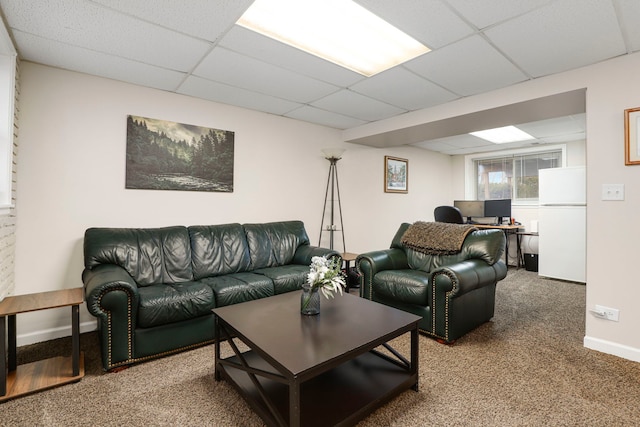 carpeted living room with a drop ceiling