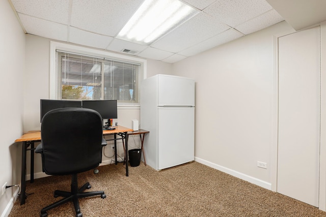 carpeted office featuring a paneled ceiling