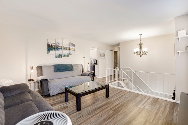 living room featuring an inviting chandelier and light hardwood / wood-style flooring