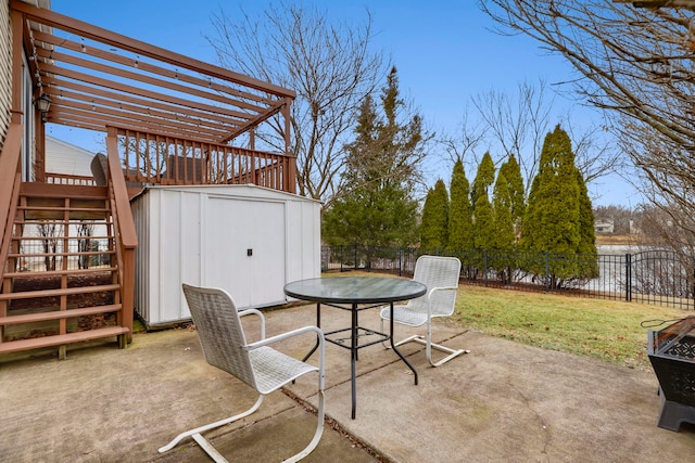 view of patio featuring a pergola, a storage unit, and a water view