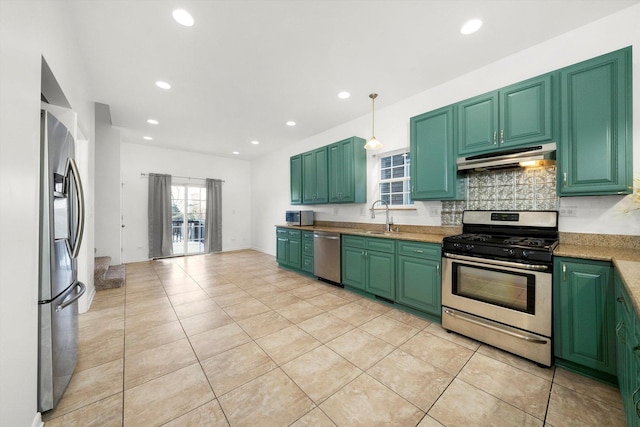 kitchen with pendant lighting, green cabinets, sink, and appliances with stainless steel finishes