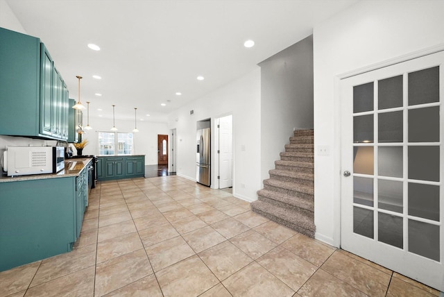 kitchen featuring light tile patterned flooring, decorative light fixtures, and stainless steel refrigerator with ice dispenser