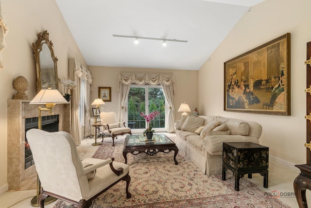 living room featuring a high end fireplace, light carpet, rail lighting, and lofted ceiling