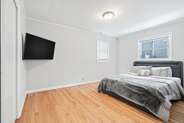 bedroom with wood-type flooring and ornamental molding