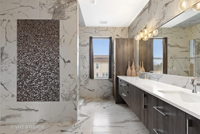 bathroom featuring vanity, walk in shower, and a healthy amount of sunlight