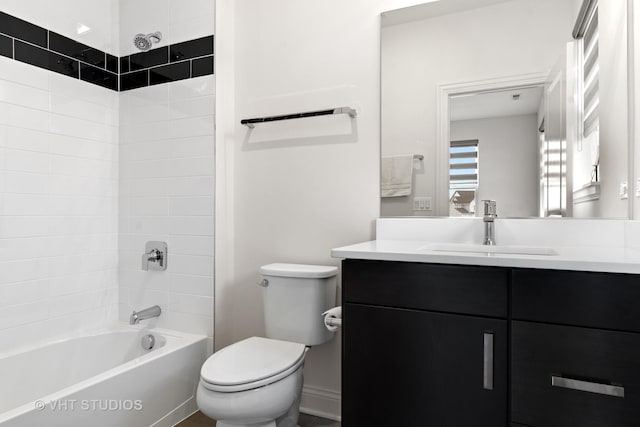 full bathroom with vanity, tiled shower / bath combo, and toilet