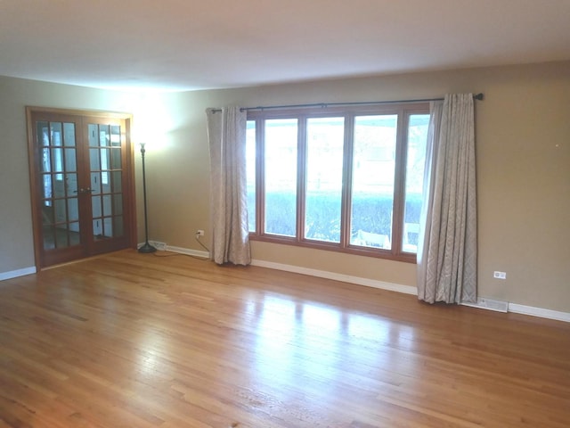 unfurnished room featuring light wood-type flooring and french doors