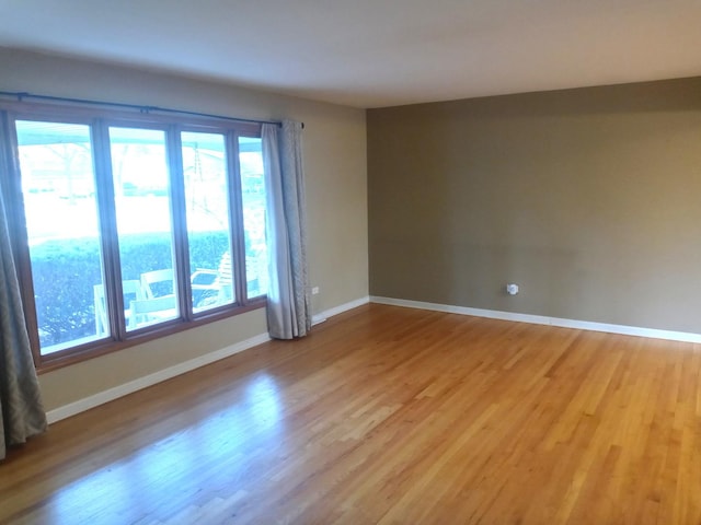 unfurnished room with light wood-type flooring