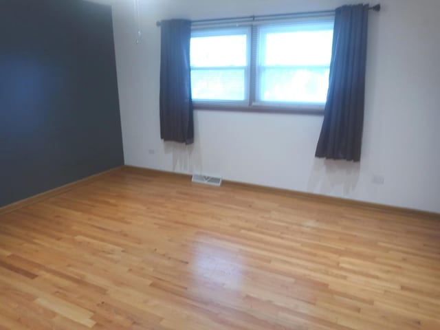 unfurnished room with light hardwood / wood-style flooring