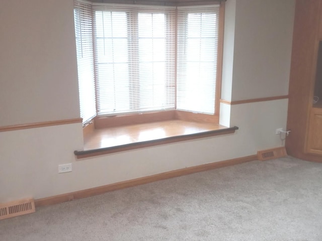 empty room with light colored carpet