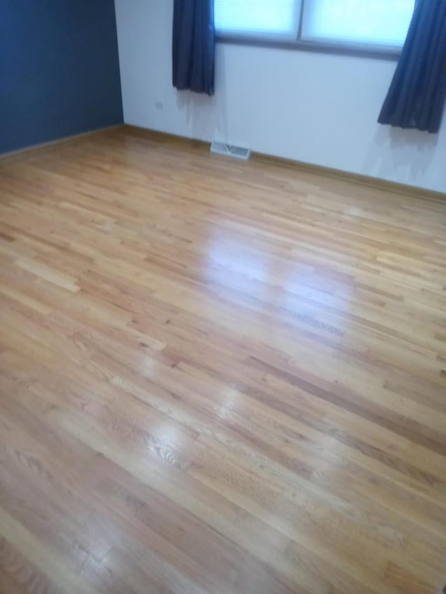 empty room with light hardwood / wood-style flooring