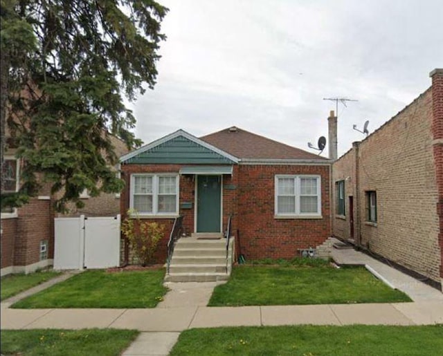 bungalow-style house featuring a front yard