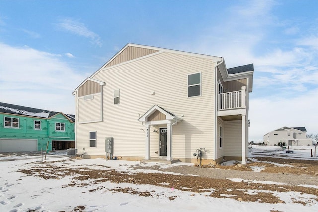 view of front of property with a balcony and central AC unit