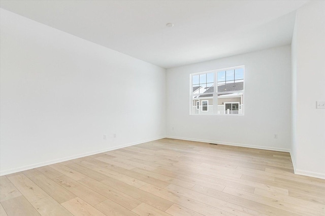 unfurnished room featuring light wood-style floors and baseboards