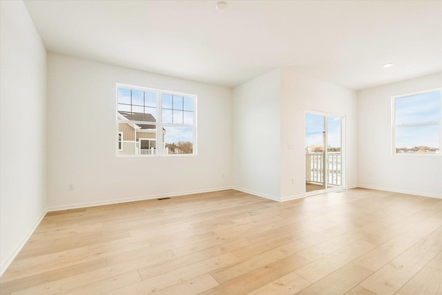 spare room with light wood-type flooring and baseboards