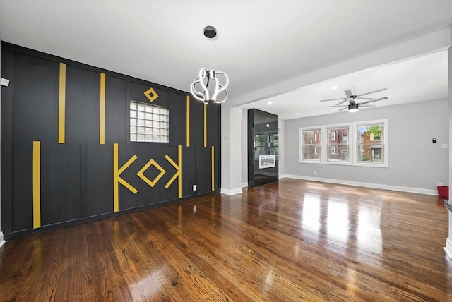 interior space with ceiling fan and dark hardwood / wood-style flooring