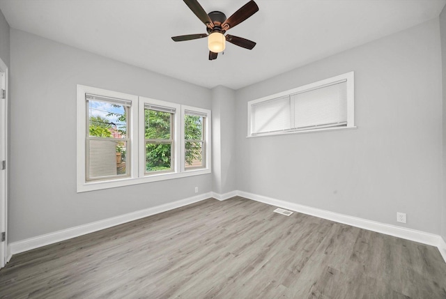 unfurnished room with ceiling fan and wood-type flooring