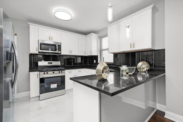 kitchen featuring kitchen peninsula, decorative backsplash, white cabinets, and stainless steel appliances