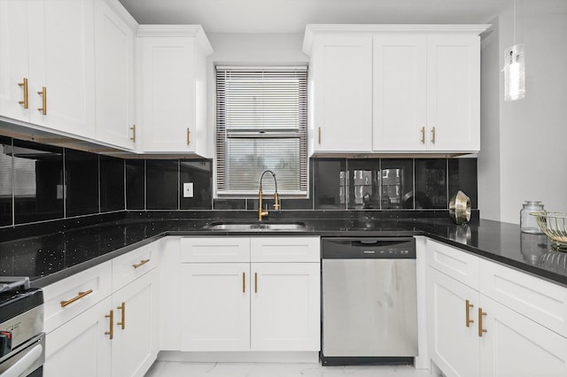 kitchen featuring white cabinets, sink, stainless steel dishwasher, decorative backsplash, and dark stone countertops