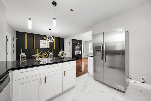 kitchen featuring pendant lighting, dark stone counters, white cabinets, stainless steel fridge, and dishwashing machine