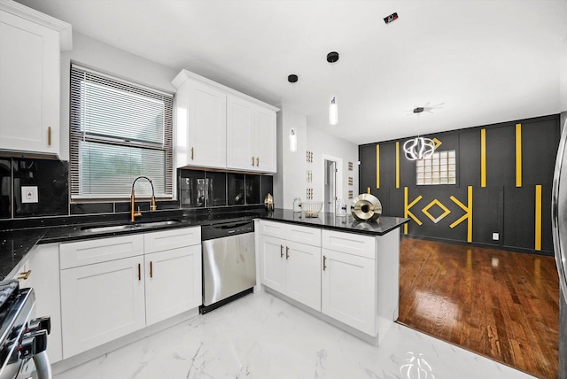 kitchen featuring sink, white cabinets, hanging light fixtures, and appliances with stainless steel finishes