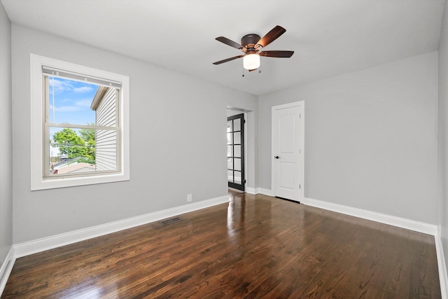 spare room featuring dark hardwood / wood-style floors and ceiling fan