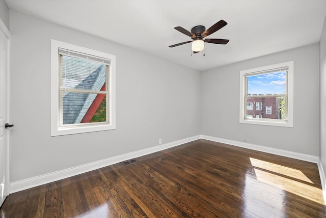 spare room with ceiling fan and dark wood-type flooring