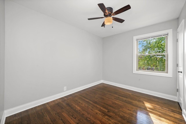 unfurnished room with ceiling fan and dark wood-type flooring