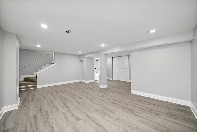 basement with hardwood / wood-style flooring