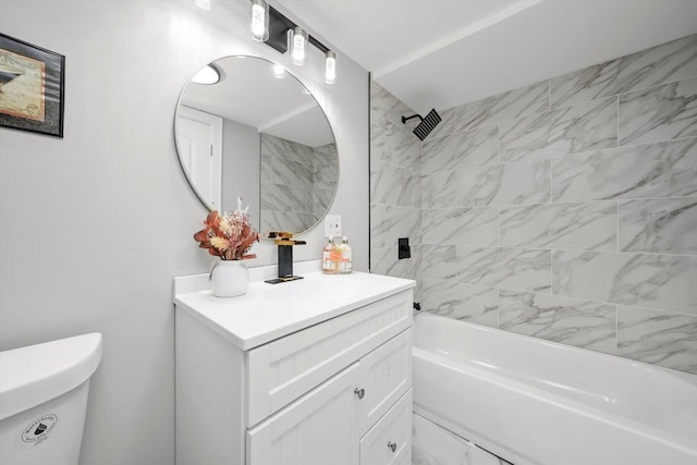 full bathroom featuring vanity, tiled shower / bath combo, and toilet