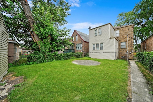 back of house with a lawn