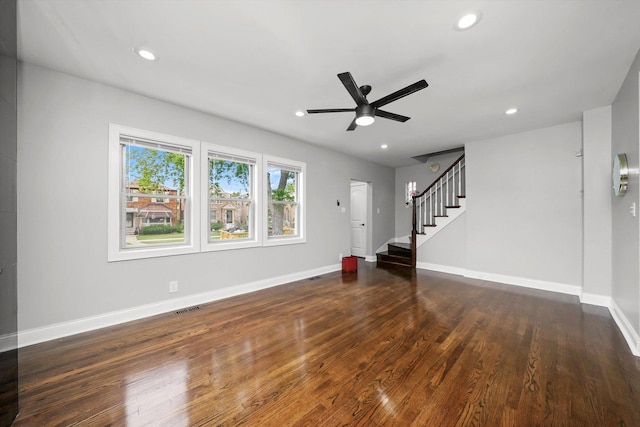 unfurnished living room featuring ceiling fan and dark hardwood / wood-style flooring