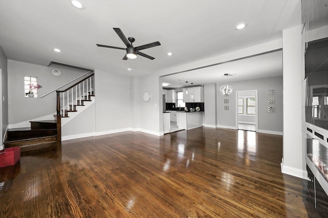 living room with ceiling fan and dark hardwood / wood-style floors