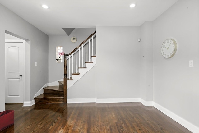 stairway with hardwood / wood-style floors