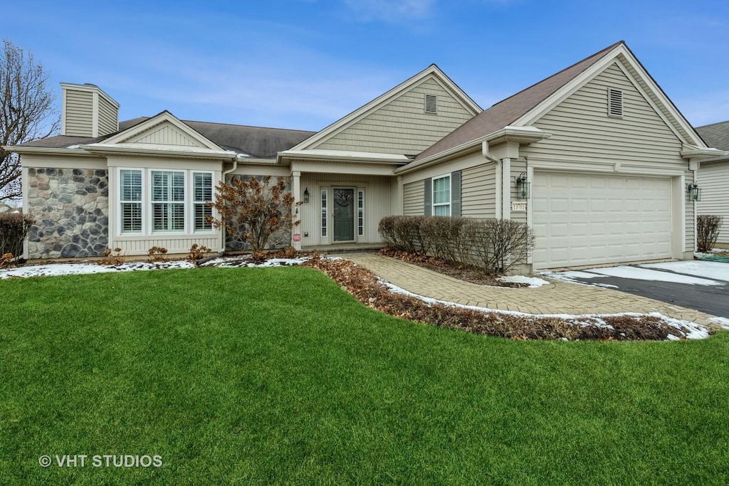 ranch-style home featuring a garage and a front yard