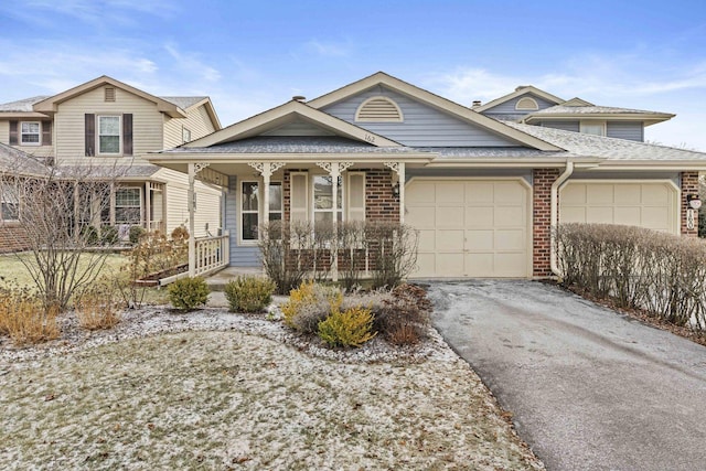 view of front of property featuring a porch and a garage