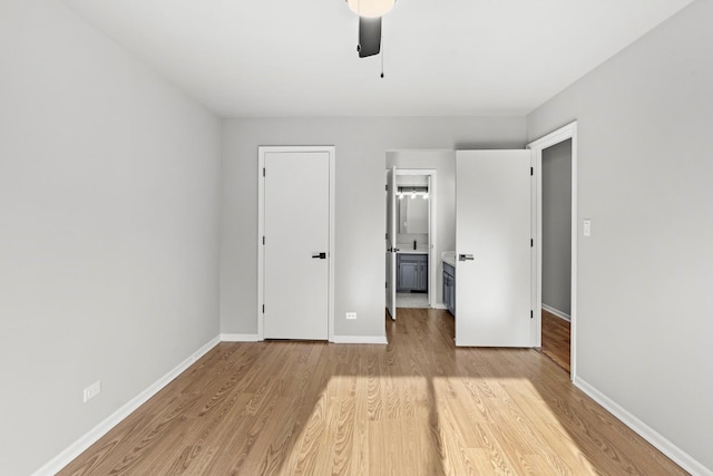 unfurnished bedroom featuring connected bathroom, ceiling fan, and light hardwood / wood-style floors