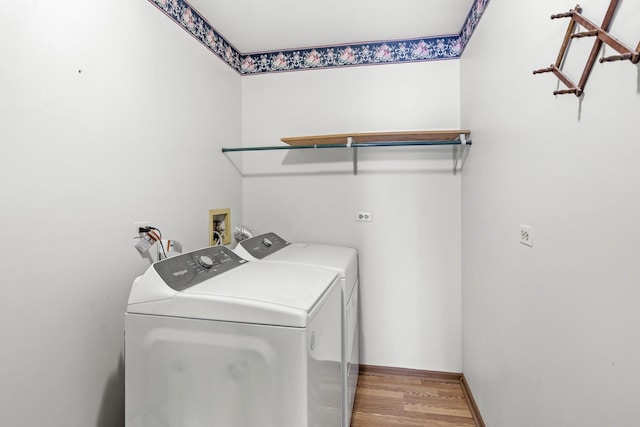 washroom with wood-type flooring and separate washer and dryer