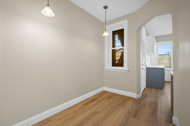 unfurnished dining area featuring hardwood / wood-style floors