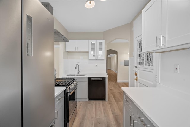 kitchen with sink, white cabinetry, gray cabinets, stainless steel appliances, and light hardwood / wood-style floors