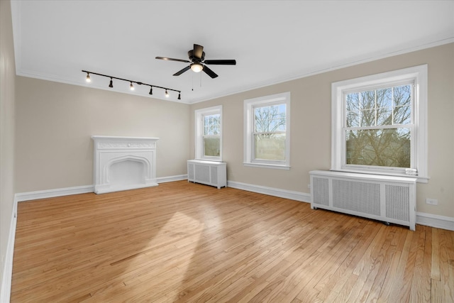 unfurnished living room with ceiling fan, ornamental molding, radiator, and light wood-type flooring