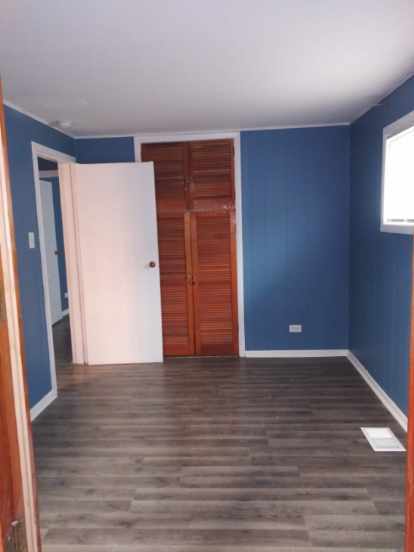 unfurnished bedroom with a closet and dark wood-type flooring