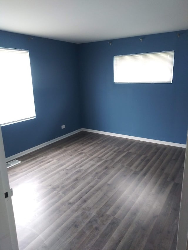 unfurnished room featuring wood-type flooring