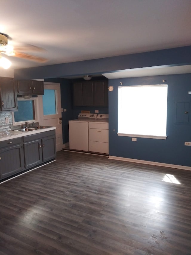 kitchen featuring sink, ceiling fan, separate washer and dryer, tasteful backsplash, and dark hardwood / wood-style flooring