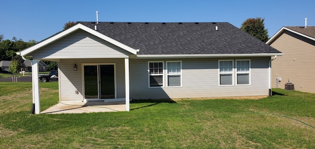 rear view of property featuring a patio area, a yard, and central AC