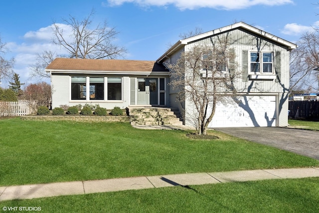 view of front of property with a garage and a front lawn