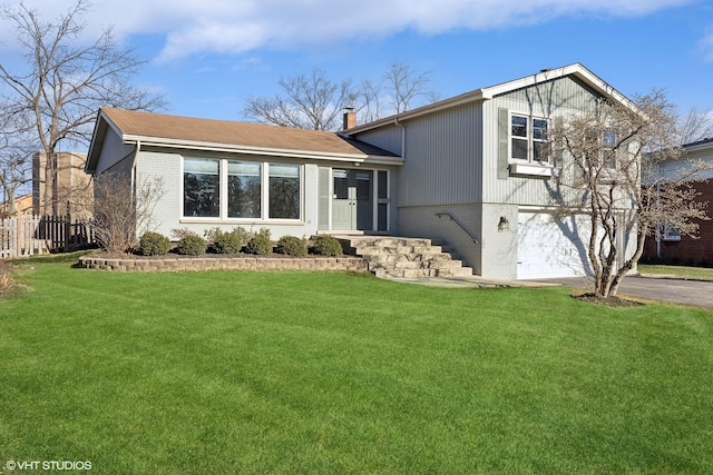 tri-level home with a garage and a front lawn