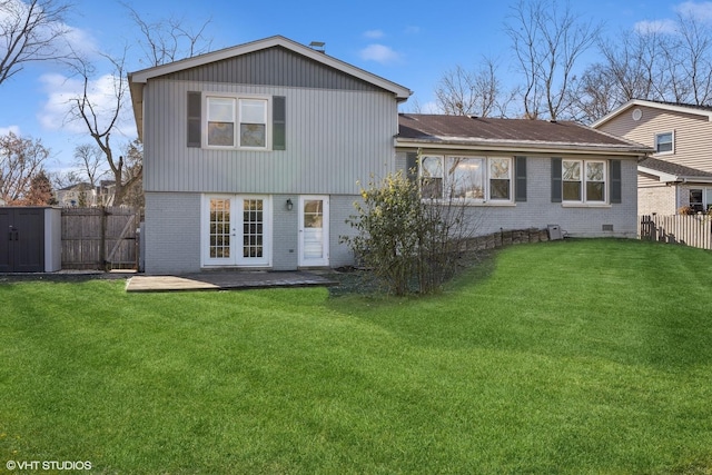 rear view of property with french doors, a patio, and a lawn