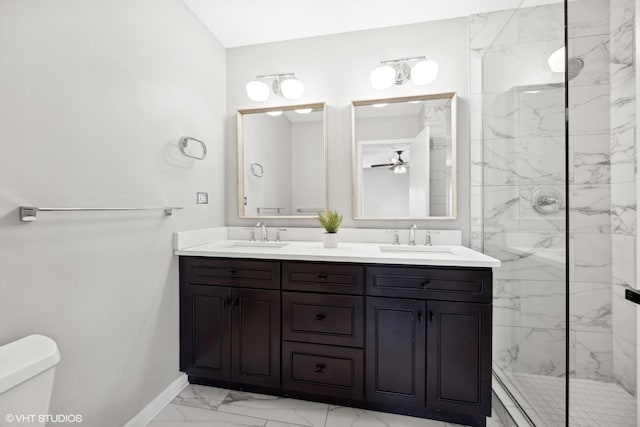 bathroom featuring ceiling fan, toilet, a tile shower, and vanity