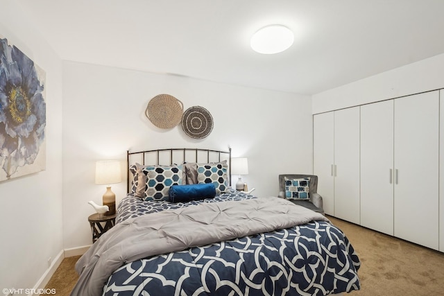 bedroom featuring a closet and light carpet